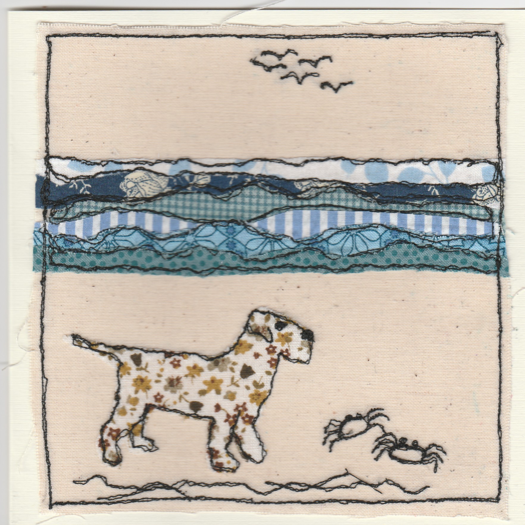 Freehand machine sewn gift card with dog on the beach near crabs