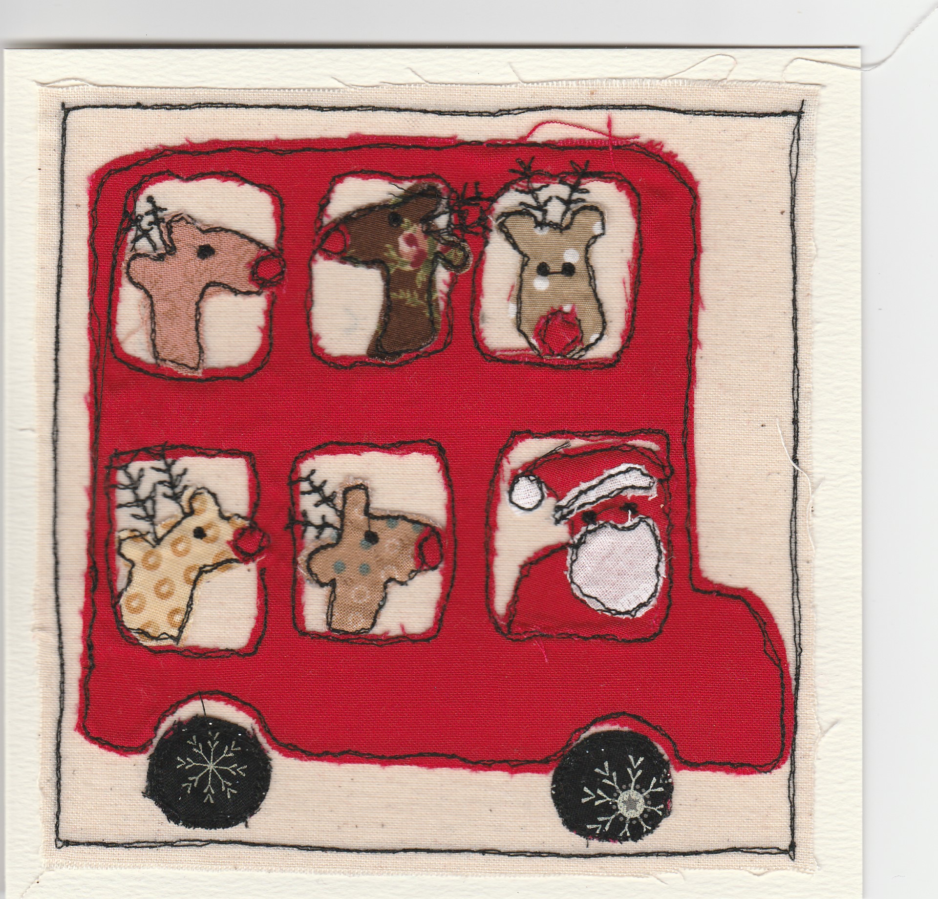 Freehand machine sewn christmas card with double decker bus driven by father christmas