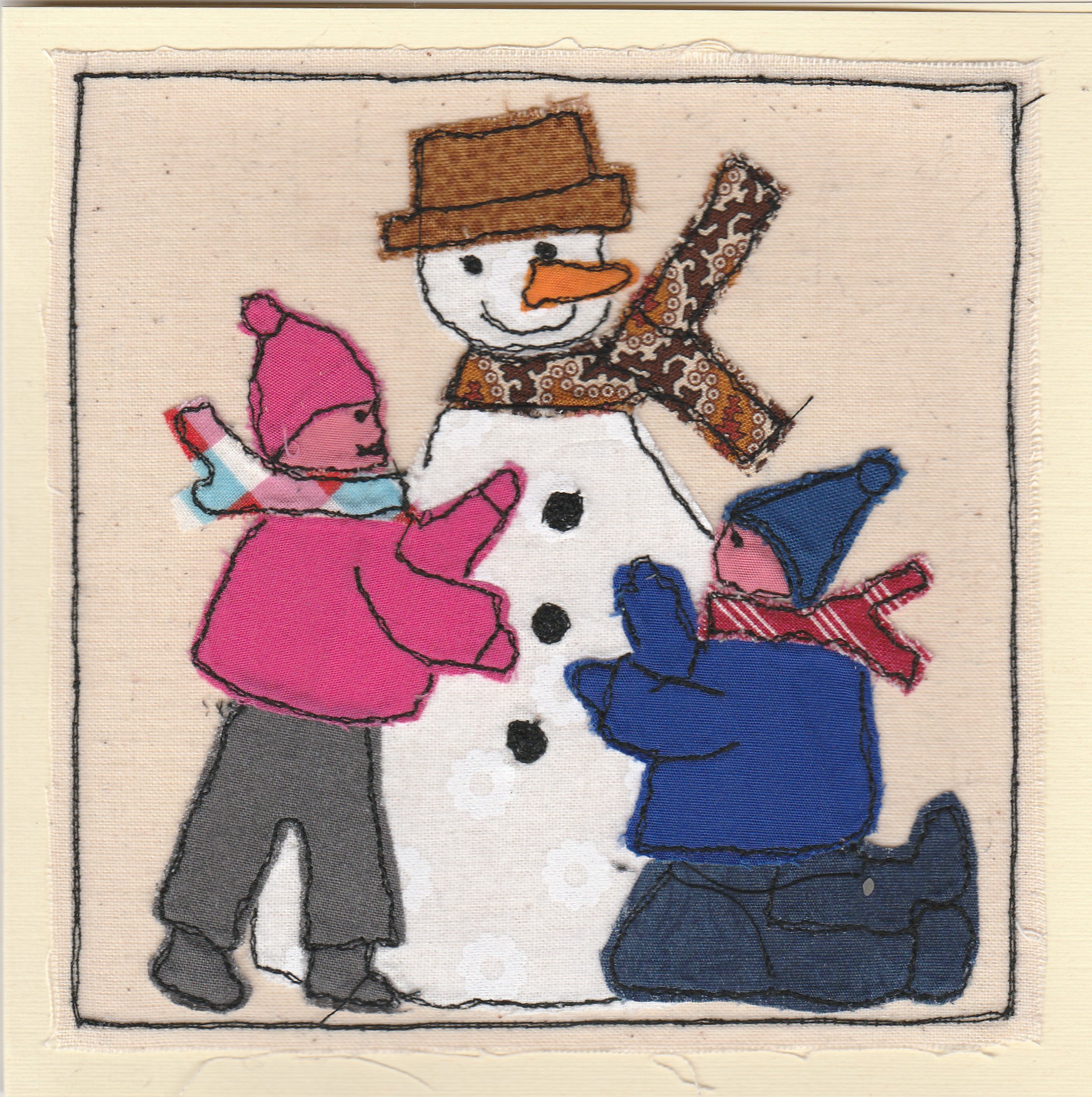 Freehand machine sewn christmas card with children building a snowman