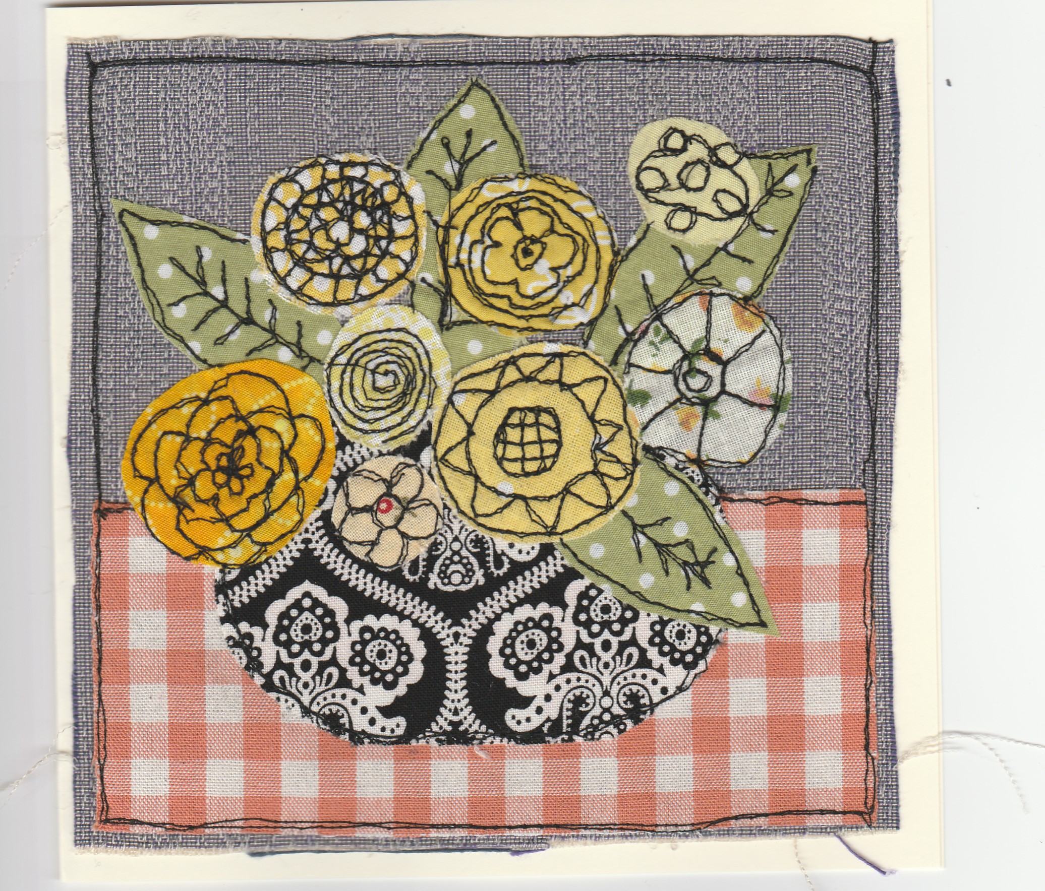 Freehand machine sewn gift card with flowers in vase on gingham tablecloth