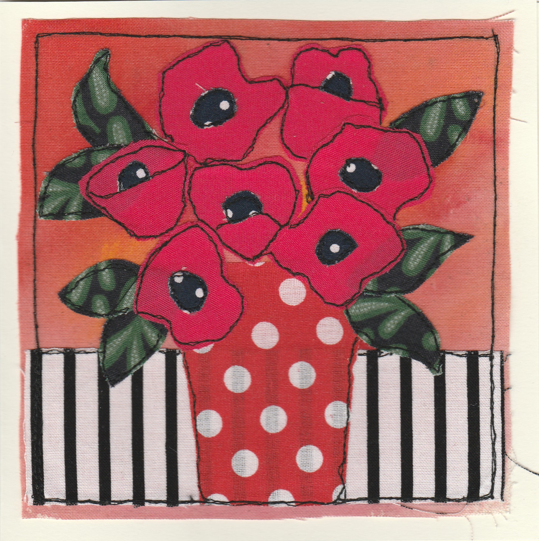 Freehand machine sewn gift card with red flowers in a spotted vase on a striped tablecloth