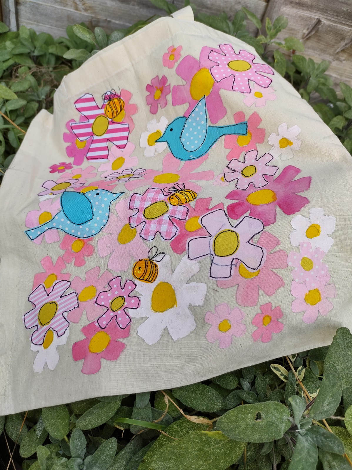 Tote bag with freehand machine sewn birds, bees and flowers design.