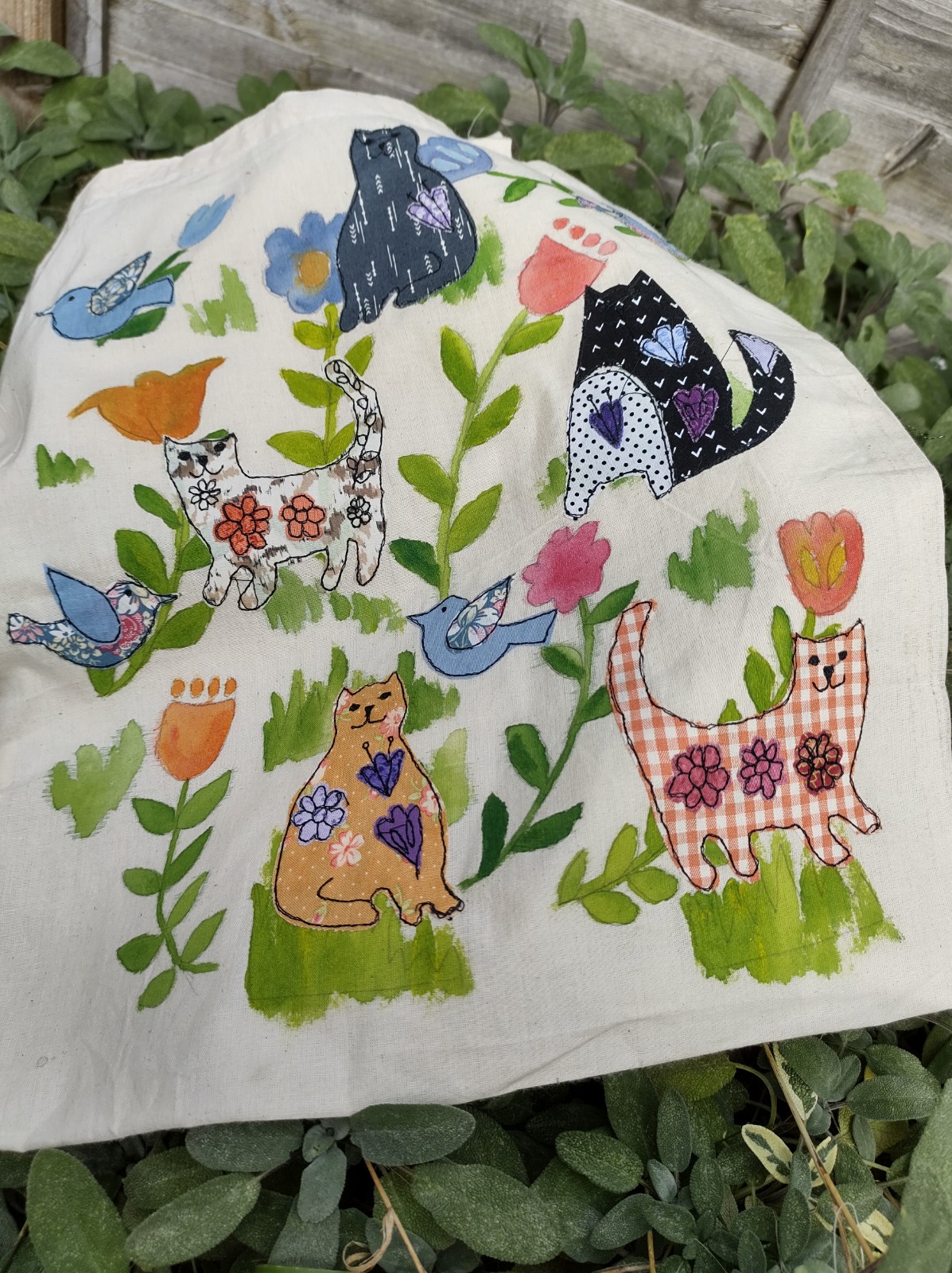 Tote bag with freehand machine sewn cats, birds and flowers design.