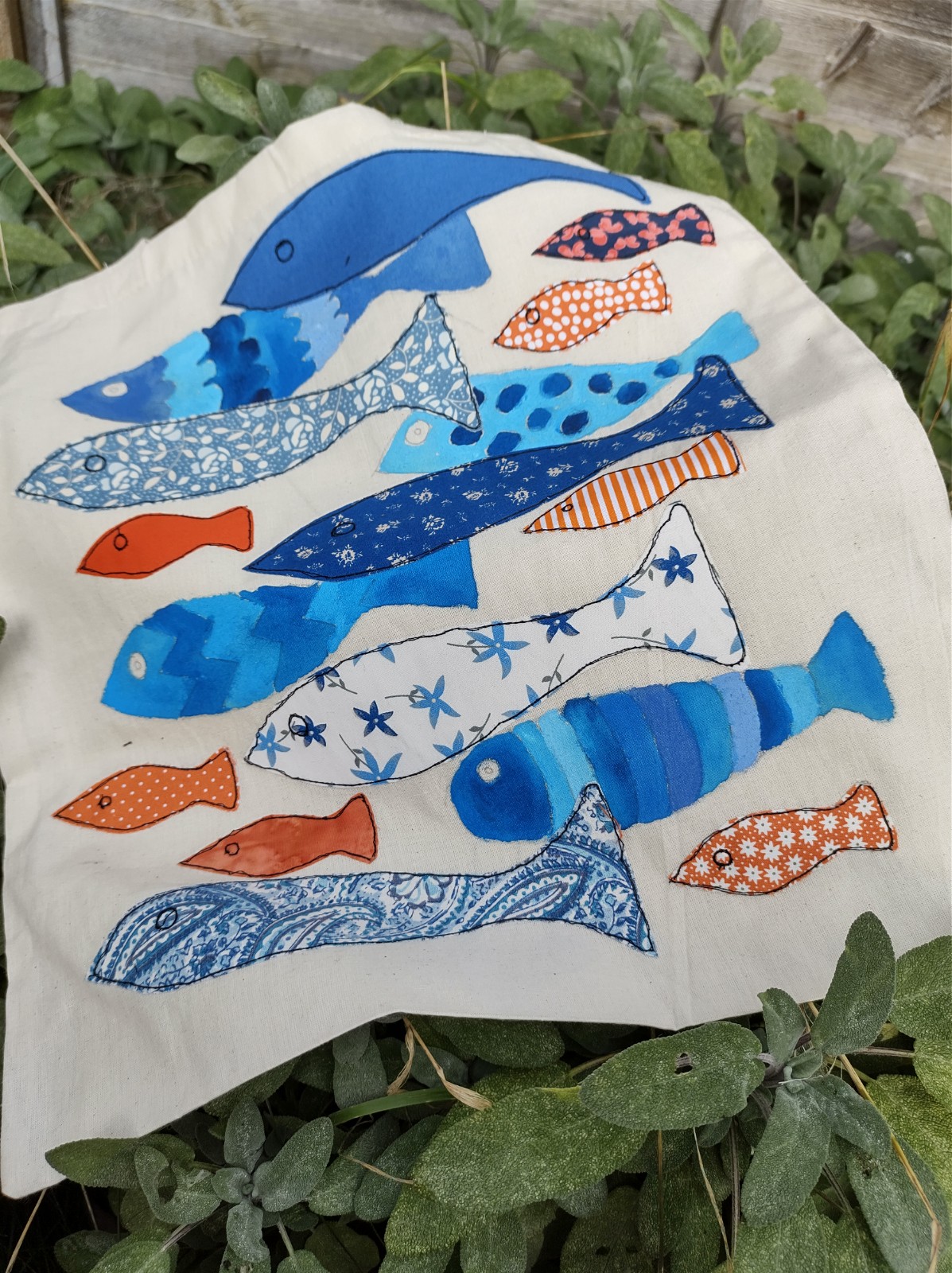 Tote bag with freehand machine sewn fish design.