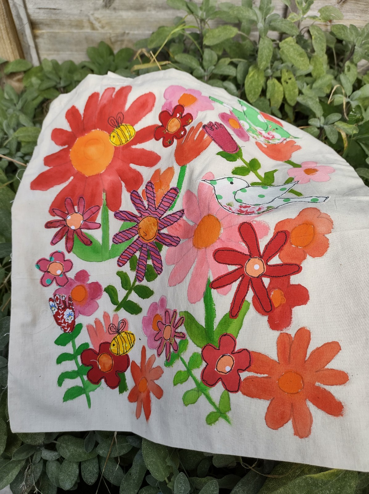 Tote bag with freehand machine sewn red flower design.